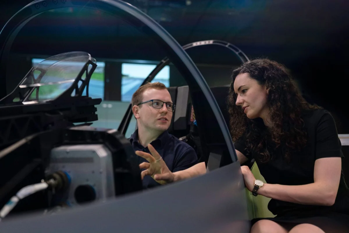 Aviation specialists working together at a flight simulator