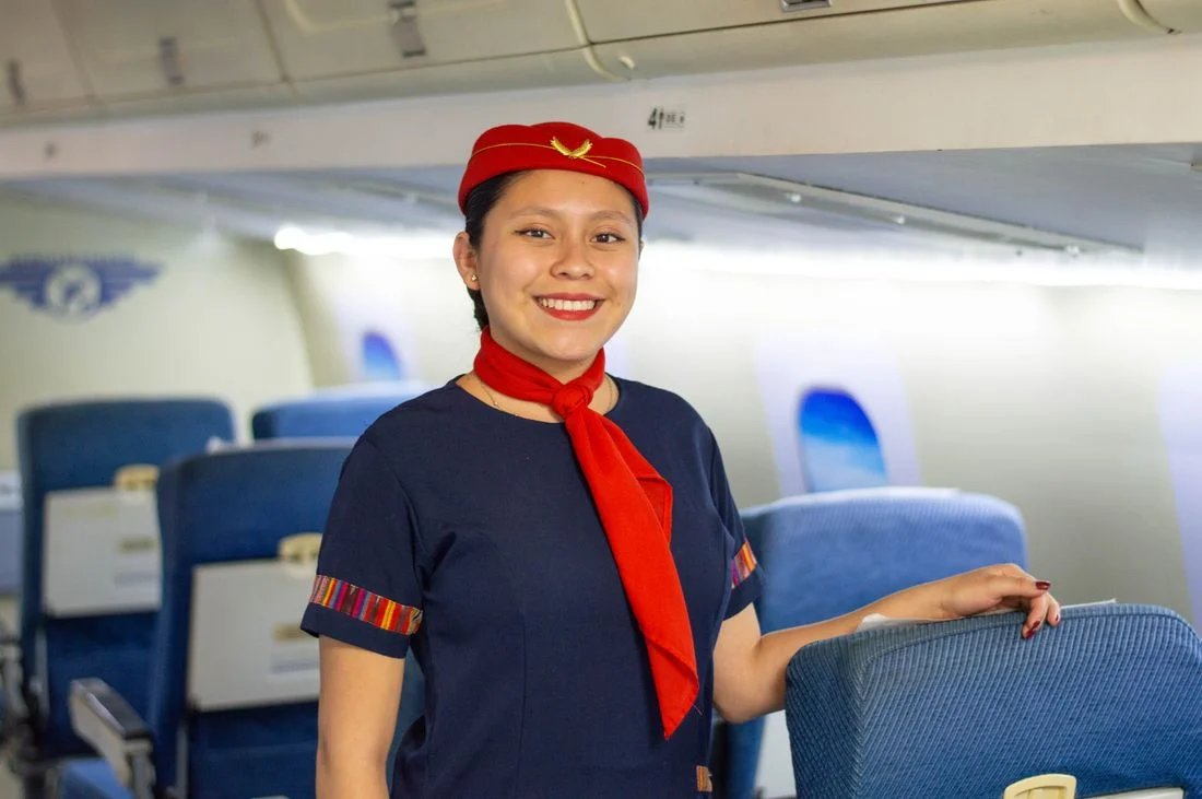 Cabin crew member beside aircraft seats — DG instructor training