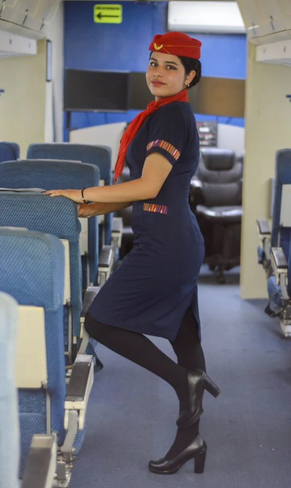 Flight attendant standing in an aircraft cabin
